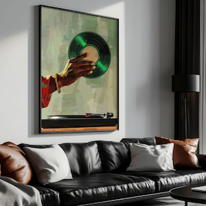 May include: A framed art print featuring a hand holding a green vinyl record. The artwork has a retro aesthetic, with a turntable visible at the bottom. The hand is wearing a bracelet and a red and green patterned sleeve.