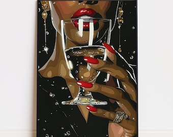May include: A framed art print featuring a woman with red lipstick and nails holding a glass of champagne. The artwork has a dark background with water droplets and gold jewelry. The woman's skin tone is brown.
