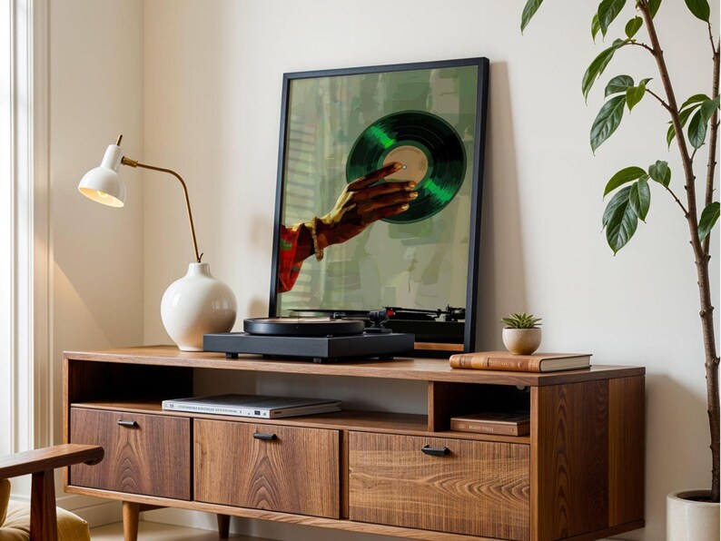 May include: A wooden media console with a framed art print of a hand holding a green vinyl record. A black turntable sits on top. A white lamp and a small plant are also on the console.