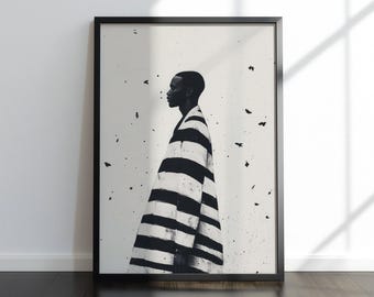 May include: Monochrome art print showing a person in profile, wearing a striking black and white striped garment. The artwork is framed in black, set against a white backdrop with dark specks. The print is displayed on a dark wooden floor.