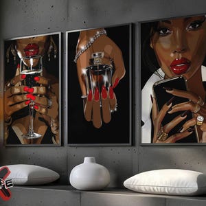May include: Three framed art prints featuring a woman with red lipstick and nails. The first print shows the woman holding a glass of champagne. The second print shows the woman holding a bottle of perfume. The third print shows the woman holding a smartphone.