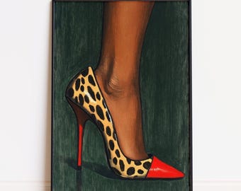 May include: A framed artwork featuring a high-heeled shoe. The shoe has a leopard print design on the upper and a red toe and heel. The artwork is set against a dark green background.
