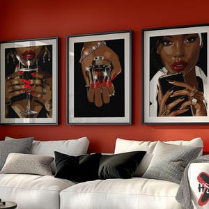 May include: Three framed art prints with black frames and white mats. Each print features a black and white illustration of a woman with red lips and nails. The woman in the left print is holding a glass of red wine. The woman in the center print is holding a bottle of perfume. The woman in the right print is holding a smartphone.