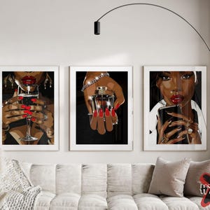 May include: Three framed illustrations of women with red lips and manicures. The first woman is holding a glass of red wine. The second woman is holding a bottle of perfume. The third woman is holding a smartphone.