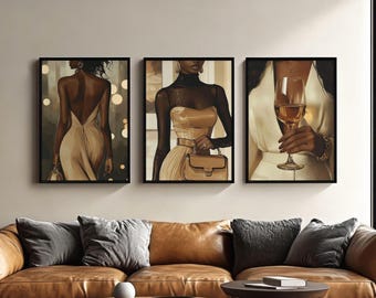 May include: Set of three framed art prints. Each print features a stylish woman in a neutral color palette. One print shows a woman in a backless dress, another shows a woman with a purse, and the last shows a woman holding a glass of wine.