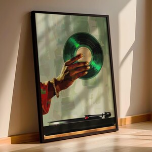 May include: A framed art print featuring a hand holding a green vinyl record. The artwork has a vintage aesthetic, with a turntable visible at the bottom. The background is a soft, abstract wash of green and white.