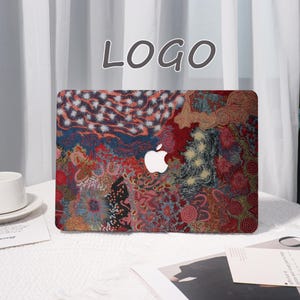 May include: A laptop case with a colorful abstract design featuring red, blue, and yellow patterns. The case has a white Apple logo and the word "LOGO" in gray at the top.