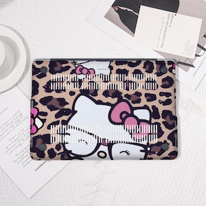 Pu&ograve; includere: Una custodia per laptop con un motivo leopardato e un personaggio di un gatto dei cartoni animati. La custodia ha una combinazione di colori bianco e rosa, con il volto e il fiocco del gatto in evidenza. Per MacBook Pro.