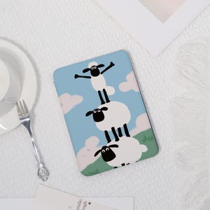 May include: A tablet case with a playful design of sheep stacked in a tower formation. The background is a light blue sky with white clouds and green grass. The top sheep has its arms outstretched.