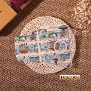 May include: A clear phone case with a colorful illustration of a musical score and whimsical characters. The case is on a woven mat. The word "Detachable" is printed on the bottom.