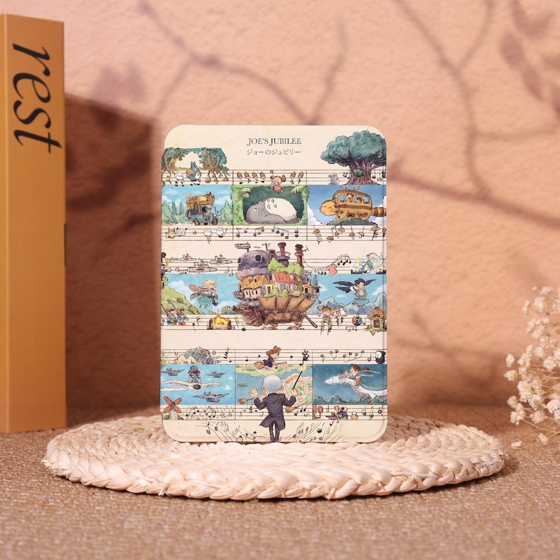 May include: A rectangular, illustrated card featuring a whimsical design with musical notes and animated characters. The card has the text "JOE'S JUBILEE" in English and Japanese. The artwork includes a conductor, a train, and other fantasy elements.