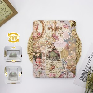 May include: A vintage-inspired digital tablet case with a collage of images, including a woman in a dress, a chandelier, and a floral pattern. The case has a light pink, white, and gold color scheme. The text "LADURÉE" is visible on the case.