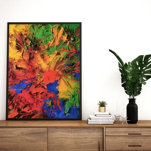 K&ouml;nnte beinhalten: Abstraktes Gem&auml;lde in einem schwarzen Rahmen mit leuchtenden Farben in Rot, Gelb, Gr&uuml;n und Blau. Das Gem&auml;lde wird auf einem Holzregal mit einer Vase und einer Topfpflanze ausgestellt.