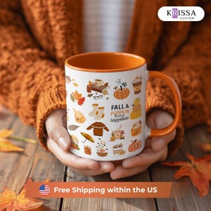 May include: A white ceramic mug with an orange interior and handle, featuring a repeating pattern of autumn-themed illustrations including pumpkins, leaves, sweaters, and coffee cups, with the text FALL & PUMPKIN bring happiness printed in black.