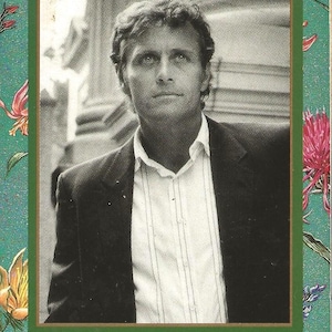 May include: A black and white photo of a man wearing a suit and a white shirt with a striped pattern. The photo is framed with a green border and floral designs. The text "Loveswept" is at the top of the frame. The text "Divinity Brown Helen Mittermeyer" is at the bottom of the frame. The text "Bantam Books" is at the bottom left corner of the frame.