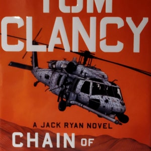 May include: A book cover with an orange background featuring a black and white helicopter and the text "#1 NEW YORK TIMES BESTSELLING AUTHOR TOM CLANCY A JACK RYAN NOVEL CHAIN OF COMMAND BY MARC CAMERON"