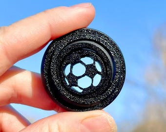 Juguete sensorial giratorio de fútbol impreso en 3D con brillo