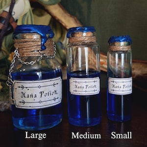 May include: Three glass bottles with blue liquid and cork stoppers. Each bottle has a label that reads "Mana Potion." The bottles are labeled "Large," "Medium," and "Small."