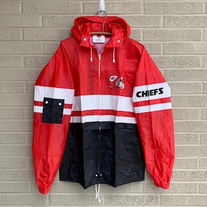 May include: A red and black striped hooded raincoat with the Kansas City Chiefs logo and the word "CHIEFS" on the sleeve.