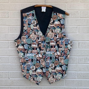 May include: A vintage vest with a black back and a colorful tapestry front. The tapestry features a repeating pattern of perfume bottles in various shapes and colors, including blue, brown, and white. The vest has a V-neck and button closure.