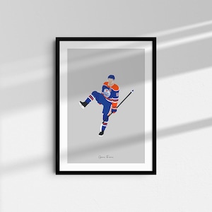 May include: A digital illustration of a hockey player wearing a blue and orange jersey with the number 97 on it. The player is skating with a stick in their hand. The background is a light grey colour. The text "Game Frame" is at the bottom of the image.