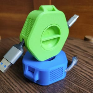 Organizador/enrollador de cables portátil