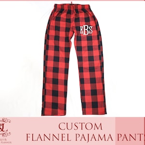 May include: Red and black plaid flannel pajama pants with the initials "EBS" embroidered on the left leg.