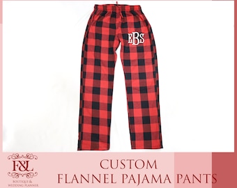May include: Red and black plaid flannel pajama pants with the initials "EBS" embroidered on the left leg.