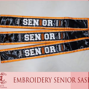 May include: Three black satin sashes with orange borders and silver rhinestone trim. Each sash features the white embroidered text SENIOR 2025, the name Mia, Maddie, or Nia, and the text SMHS Dance Team in orange and white embroidery.