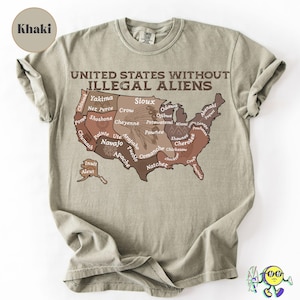 May include: Khaki-colored t-shirt with the text "UNITED STATES WITHOUT ILLEGAL ALIENS" above a map of the United States, with tribal names. The shirt is made of a soft material.