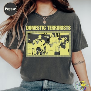 May include: A set of three ceramic mugs with a speckled, matte finish. The mugs are in shades of cream, light gray, and dark gray. Each mug has a simple, minimalist design, perfect for coffee or tea.