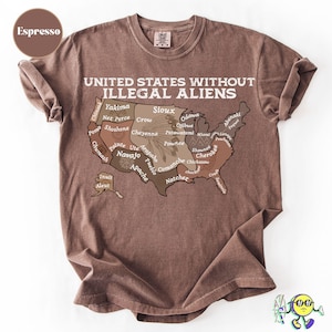 May include: Espresso-colored t-shirt with the text "UNITED STATES WITHOUT ILLEGAL ALIENS" above a map of the United States, with various Native American tribes labeled within the states. The shirt is made of a soft material.