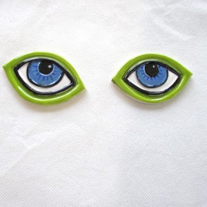 May include: A set of three ceramic mugs with a speckled, matte finish. The mugs are in shades of cream, light gray, and dark gray. Each mug has a simple, minimalist design, perfect for coffee or tea.