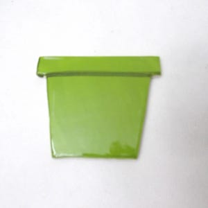 May include: A lime green ceramic flower pot with a smooth, glossy finish. The pot features a tapered body that narrows toward the base and a wide, flat rim at the top. The design is simple and functional, showcasing a vibrant, solid color.