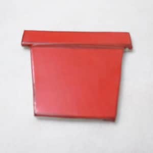 May include: A bright red, rectangular object with a slightly raised top edge. The object has a smooth, glossy finish and appears to be made of a solid material. The item is set against a plain white background.