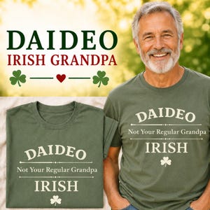 May include: An olive green t-shirt with the text "DAIDEO Not Your Regular Grandpa IRISH" in white. The design includes a shamrock. A man wearing the shirt is smiling.