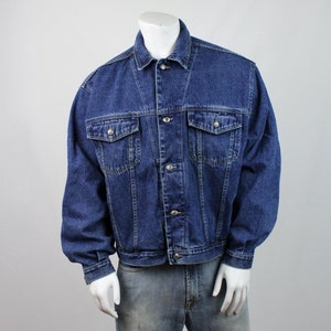 May include: A blue denim jacket with a button closure and two front pockets. The jacket is on a mannequin and has a relaxed fit.