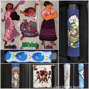 May include: A set of colorful fabric car seat handle covers featuring characters from popular Disney and Pixar movies, including Mirabel, Luisa, and Isabela from Encanto, Dory from Finding Nemo, Buzz Lightyear from Toy Story, and characters from The Incredibles.  The covers are made by Sand Dragon Sewing.