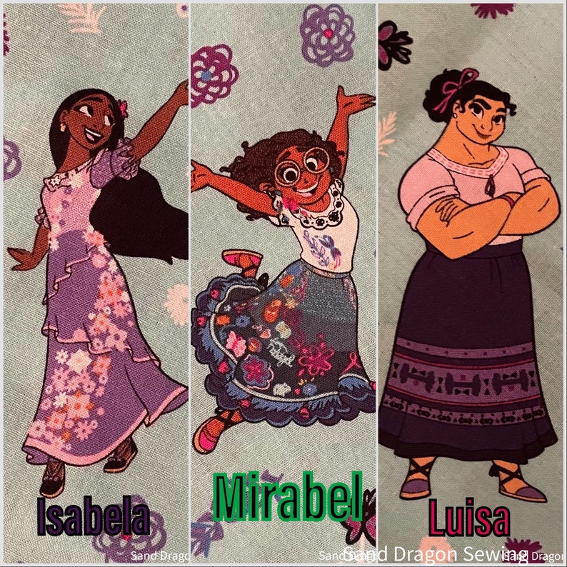 May include: Three cartoon characters from the movie Encanto.  The characters are Isabela, Mirabel, and Luisa.  Isabela is wearing a purple dress with floral designs.  Mirabel is wearing a blue and white dress with floral designs.  Luisa is wearing a purple skirt with a red and white pattern and a pink shirt.