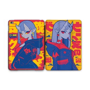 May include: Two phone cases featuring a cartoon illustration of a red-haired demon girl with horns and a red and blue jacket. The background is yellow with Japanese text.