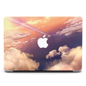 May include: Laptop cover featuring a vibrant sky scene with clouds, a shooting star, and a white Apple logo. The design showcases a gradient of colors, including pink, orange, and purple, creating a dreamy aesthetic.