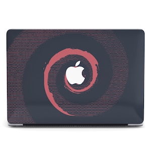 May include: A dark gray laptop skin featuring a central white Apple logo surrounded by a stylized, brushstroke-style spiral design in a muted red color. The background is filled with a subtle, repeating pattern of small, light-colored dots.