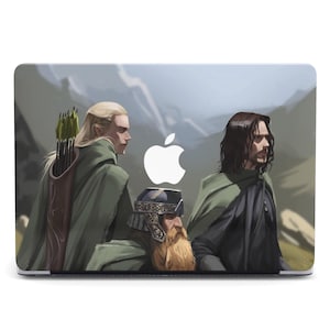 May include: A laptop skin featuring three characters from the Lord of the Rings. The characters are standing in a forest setting. The skin is designed to fit a laptop computer.