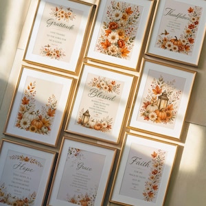 May include: A collection of eight framed wall art prints featuring autumn-themed floral arrangements, pumpkins, and lanterns. Each print displays inspirational text including Gratitude, Blessed, Hope, Grace, and Faith, set in gold-toned frames.