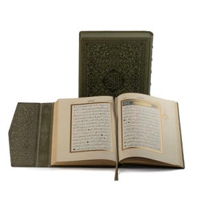 Peut inclure: Un livre relié en cuir vert ouvert avec des accents dorés et du texte arabe sur les pages. Le livre est ouvert à une page avec une bordure dorée et du texte arabe.