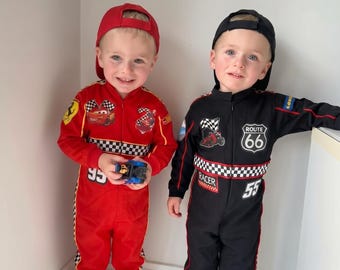 May include: A red racing jumpsuit with a checkered pattern, the number 95, and a cartoon car graphic, paired with a red baseball cap. A black racing jumpsuit with a checkered pattern, the number 55, and a Route 66 patch, paired with a black baseball cap.