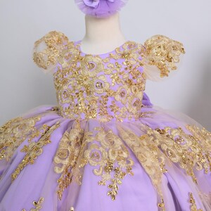 a purple and gold dress on a mannequin