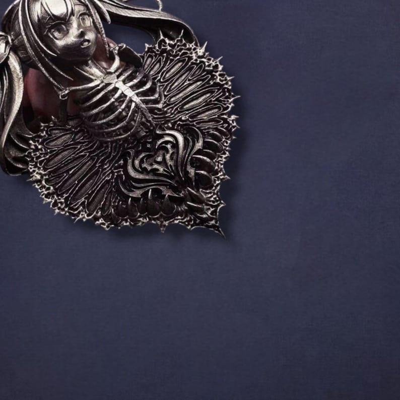 May include: A detailed, silver-toned pendant featuring a stylized female figure with a skeletal ribcage design. The pendant has intricate, ornate detailing and is set against a dark blue background. The design has a gothic or fantasy theme.