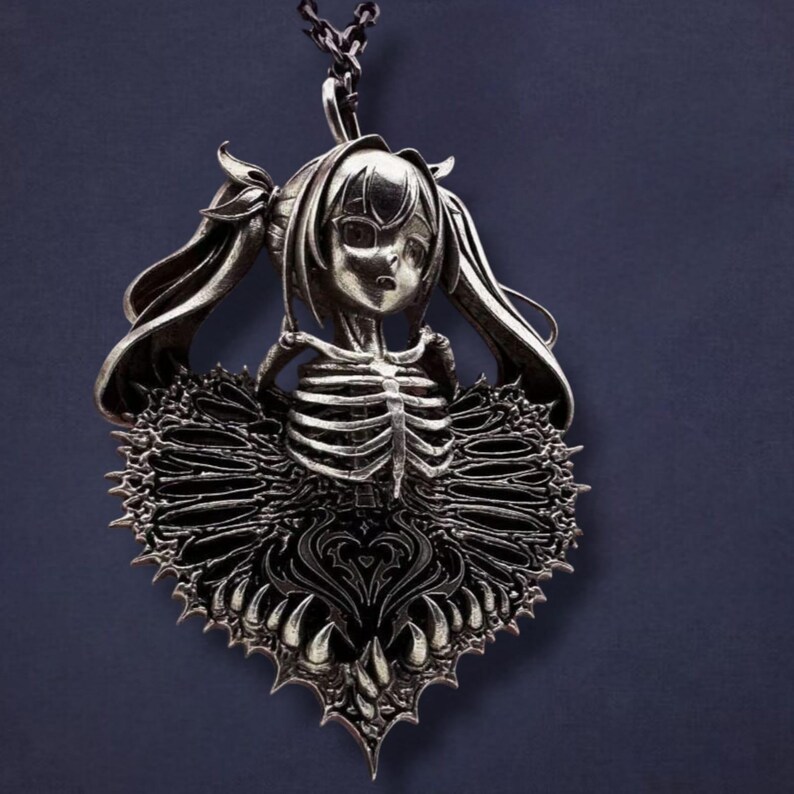 May include: Silver-toned pendant necklace featuring a stylized anime-style girl with a skeleton torso and a heart-shaped, spiky skirt. The pendant hangs from a delicate chain, creating a gothic and unique aesthetic.