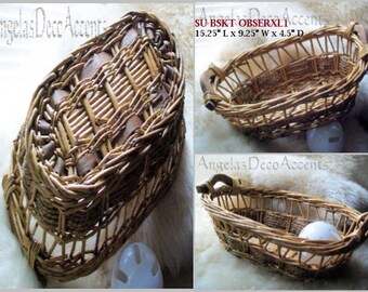 May include: Woven wicker basket with a rectangular shape and handles. The basket is approximately 38.7 cm long, 23.5 cm wide, and 11.4 cm deep. The basket has a natural brown colour and is likely used for storage or display.